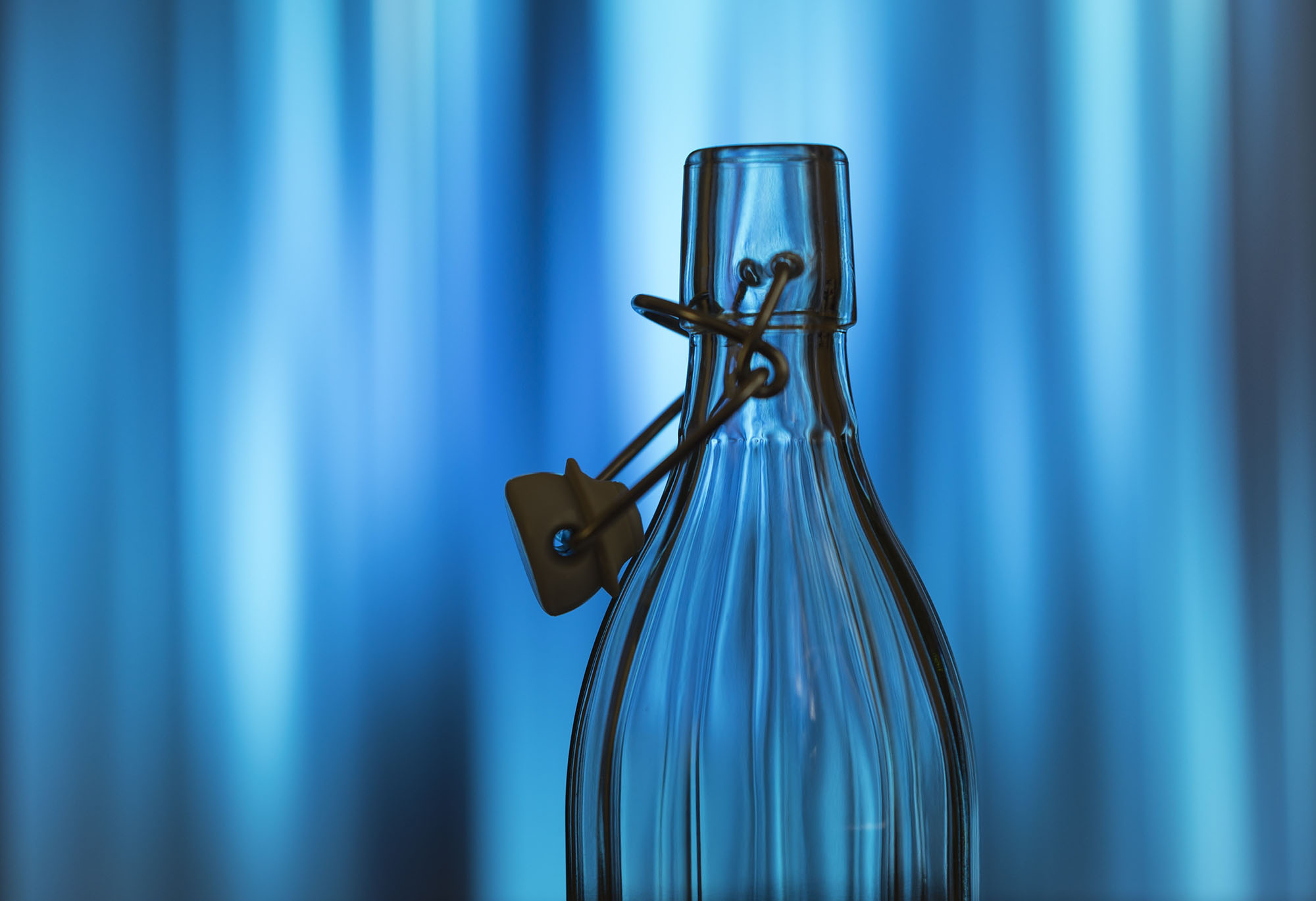 A silouette of a glass liquid caraff with stopper. The image was obtained from Unsplash at https://unsplash.com/photos/aZcv8wN30NI